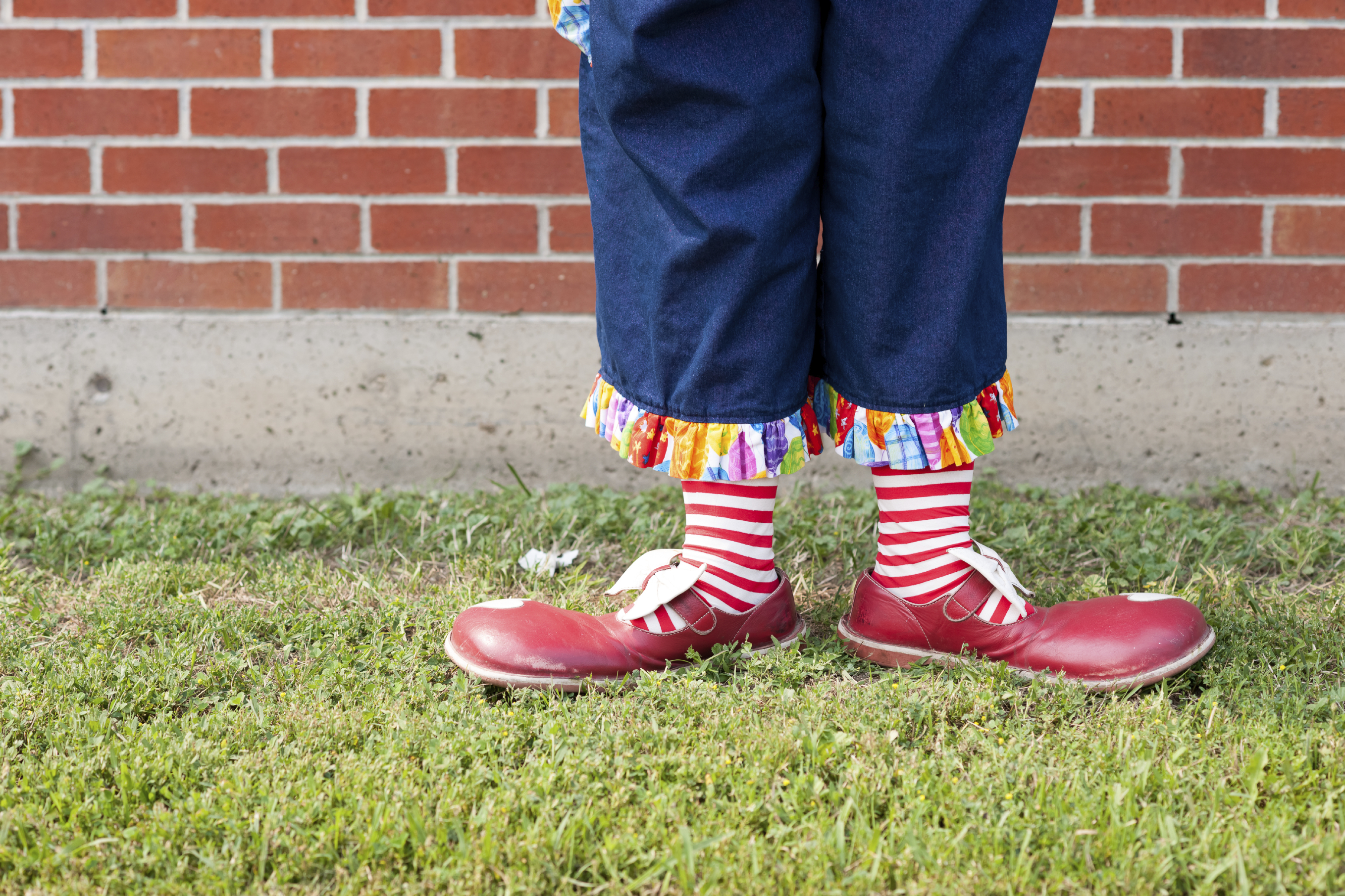 A pretty clown performs in a variety of stunts and poses.